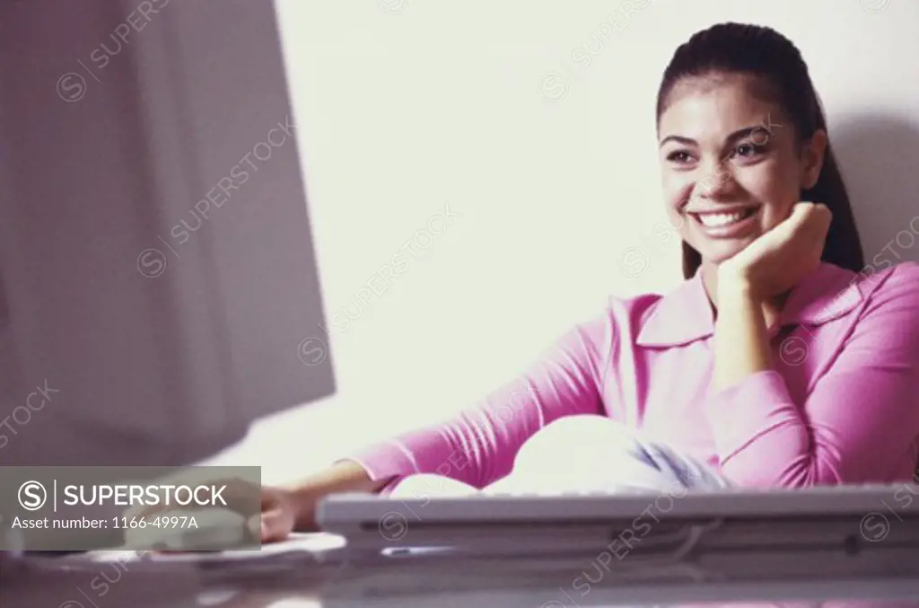 Close-up of a teenage girl using a computer