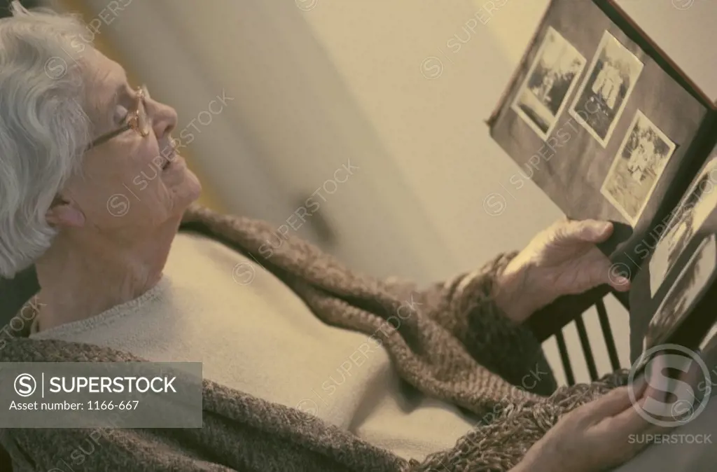 Senior woman looking at a photo album