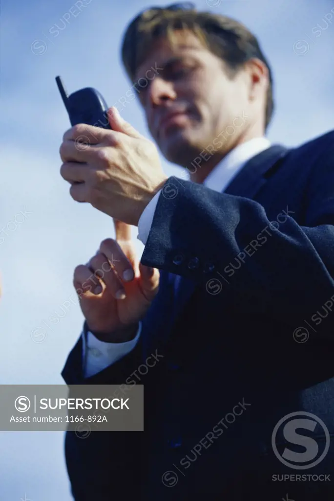 Low angle view of a businessman using a mobile phone