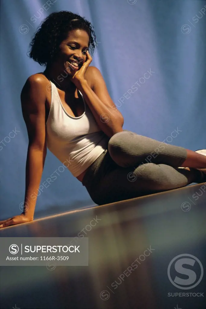 Young woman sitting on the floor smiling