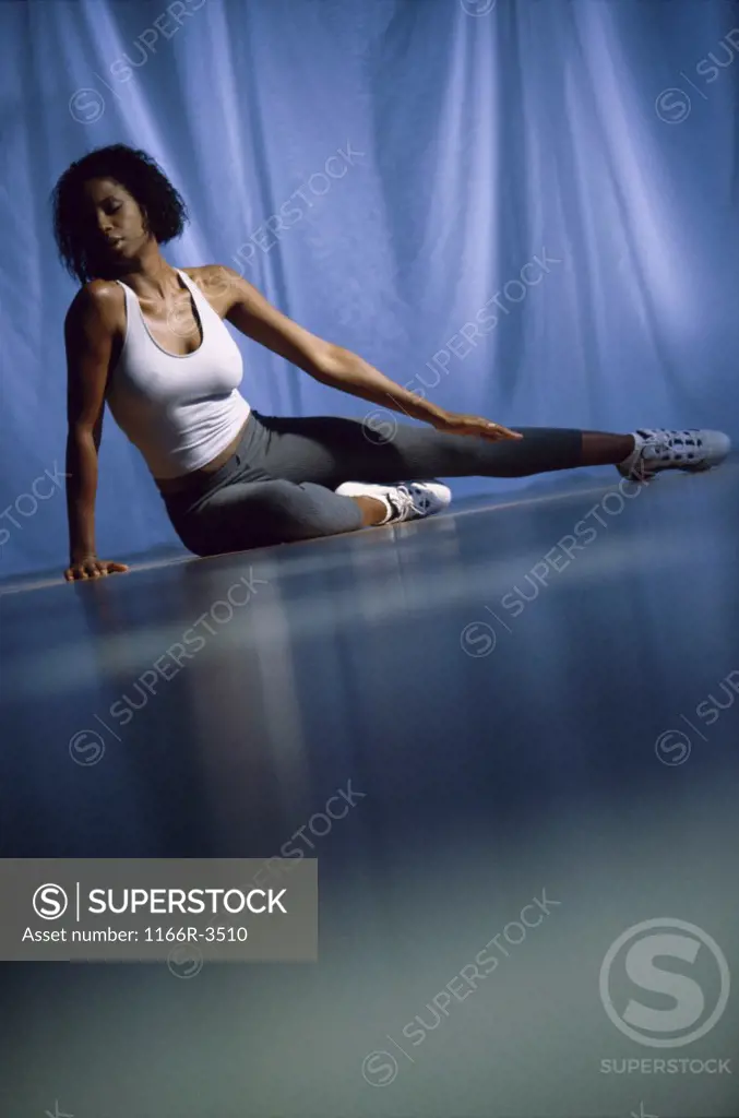 Young woman doing yoga on the floor