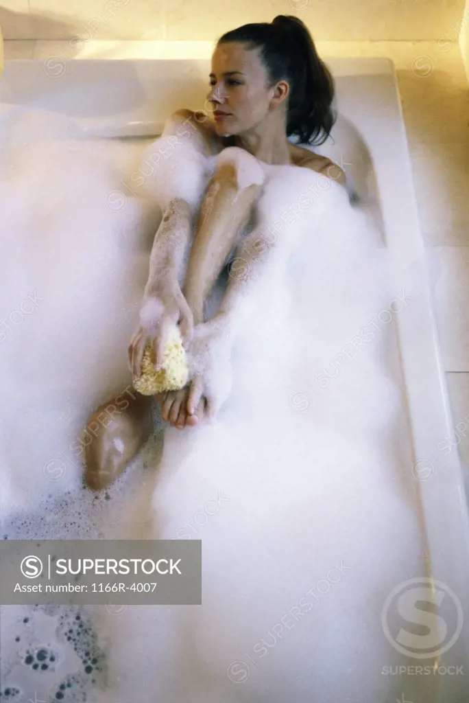 High angle view of a young woman in a bubble bath