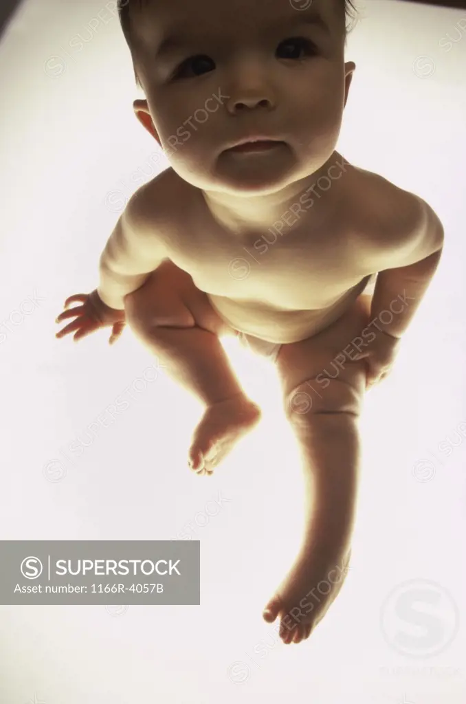 Close-up of a baby sitting in diapers