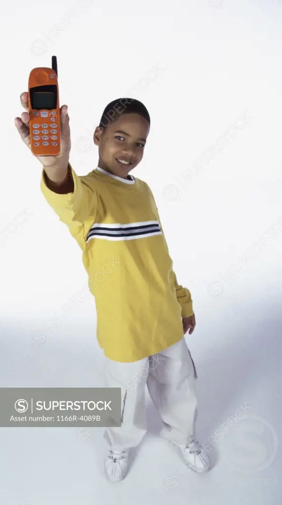 Portrait of a boy holding a mobile phone