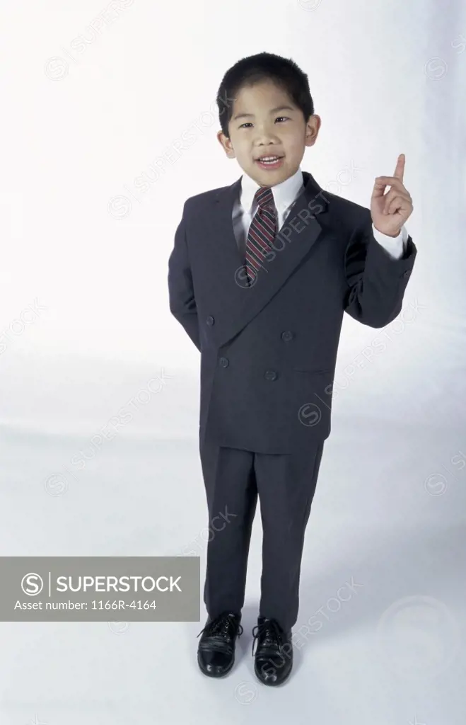 Portrait of a young boy dressed as a businessman