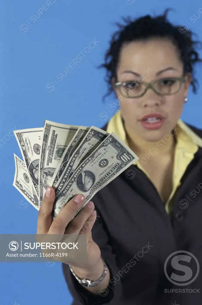 Portrait of a young woman holding paper money