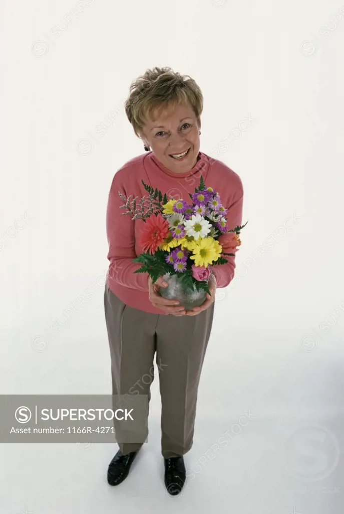 Portrait of a senior woman holding a bouquet of flowers