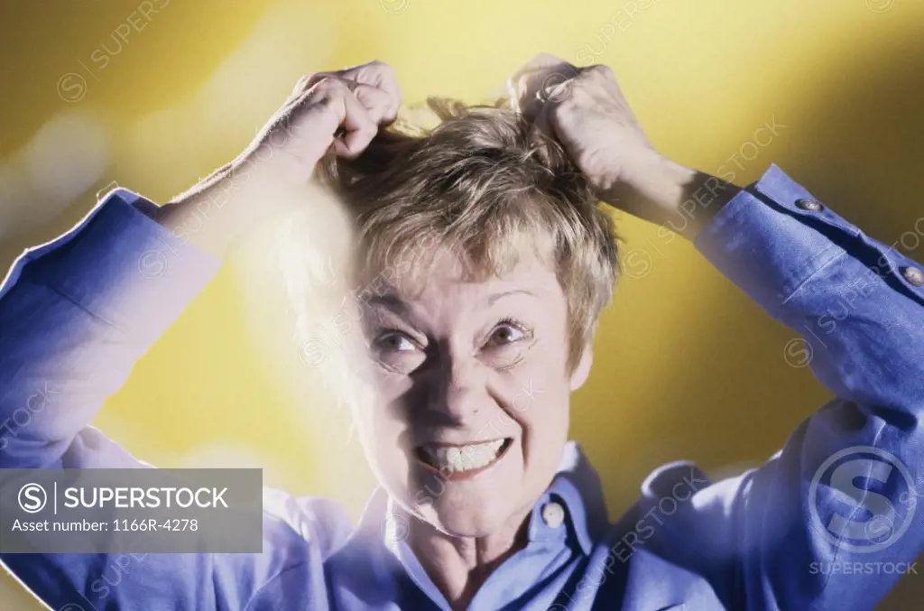 Senior woman pulling her hair