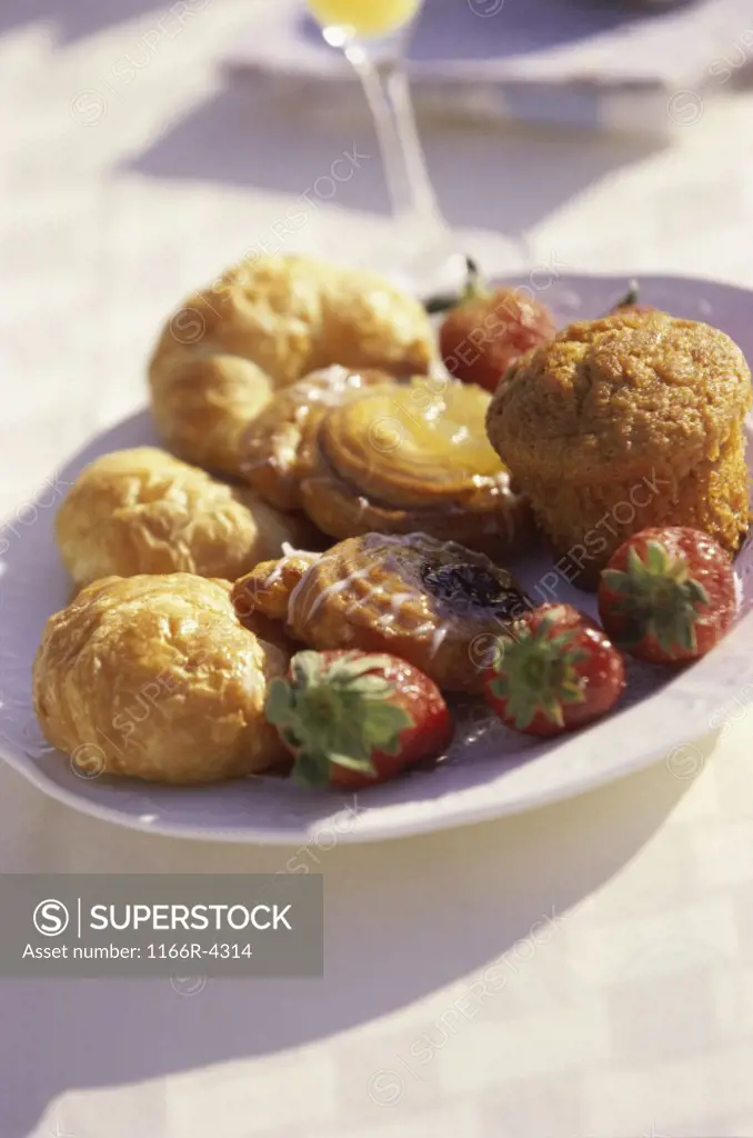 Close-up of a plate of pastries and strawberries