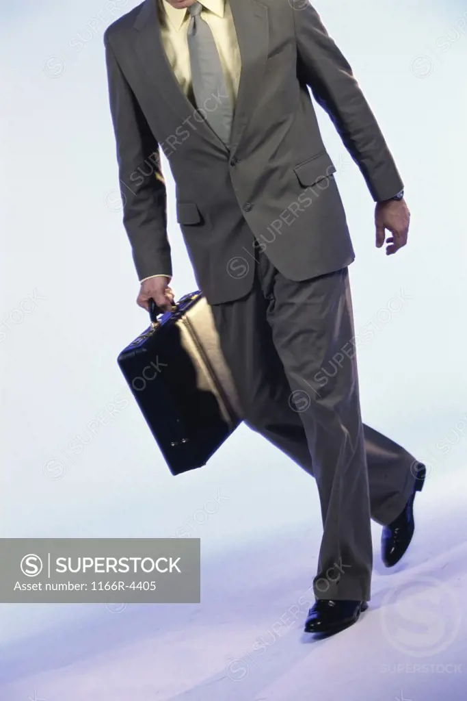 Businessman walking holding a briefcase