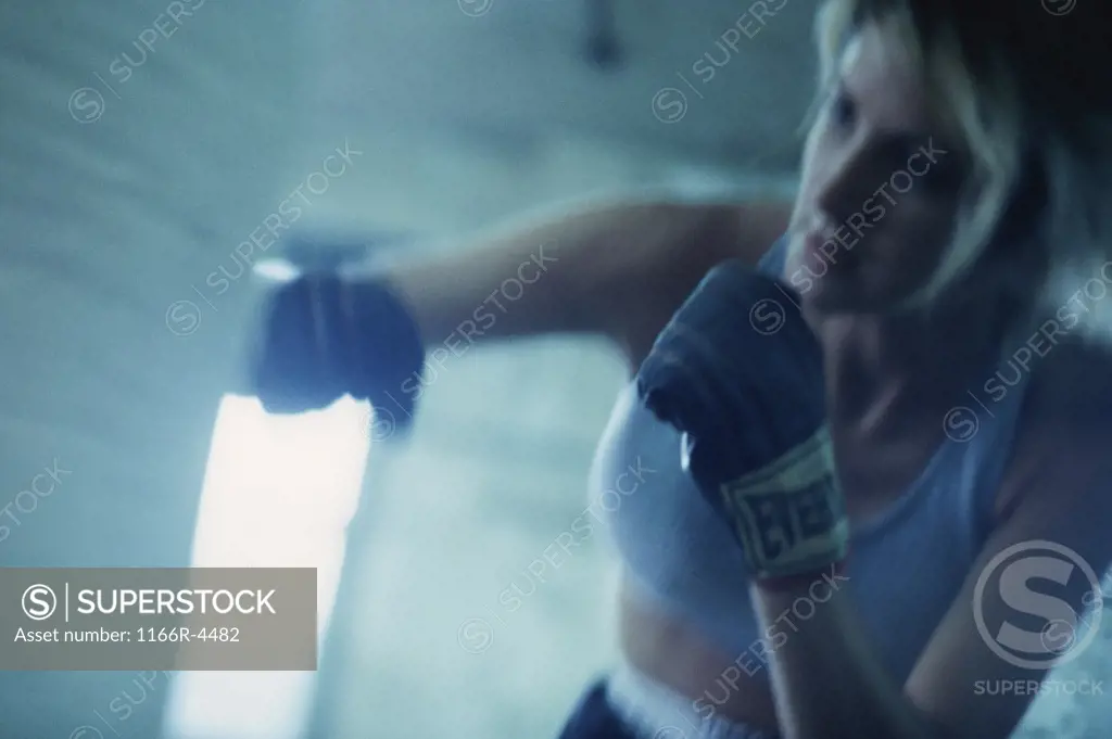 Female boxer punching a punching bag