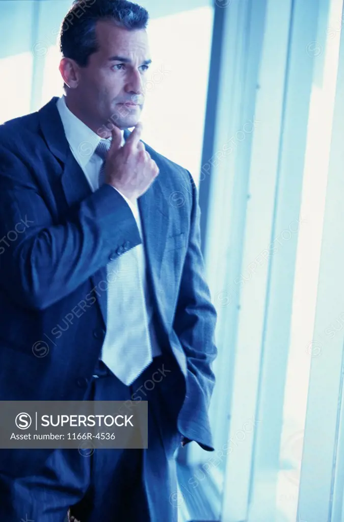 Businessman thinking with his hand on his chin