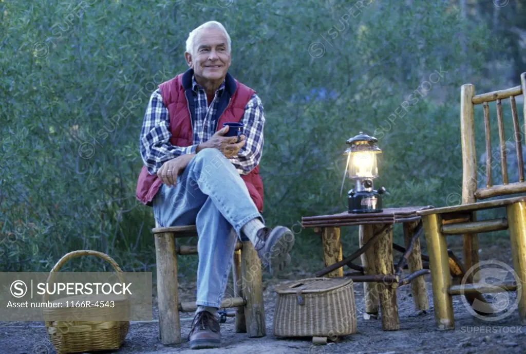 Portrait of a senior man camping