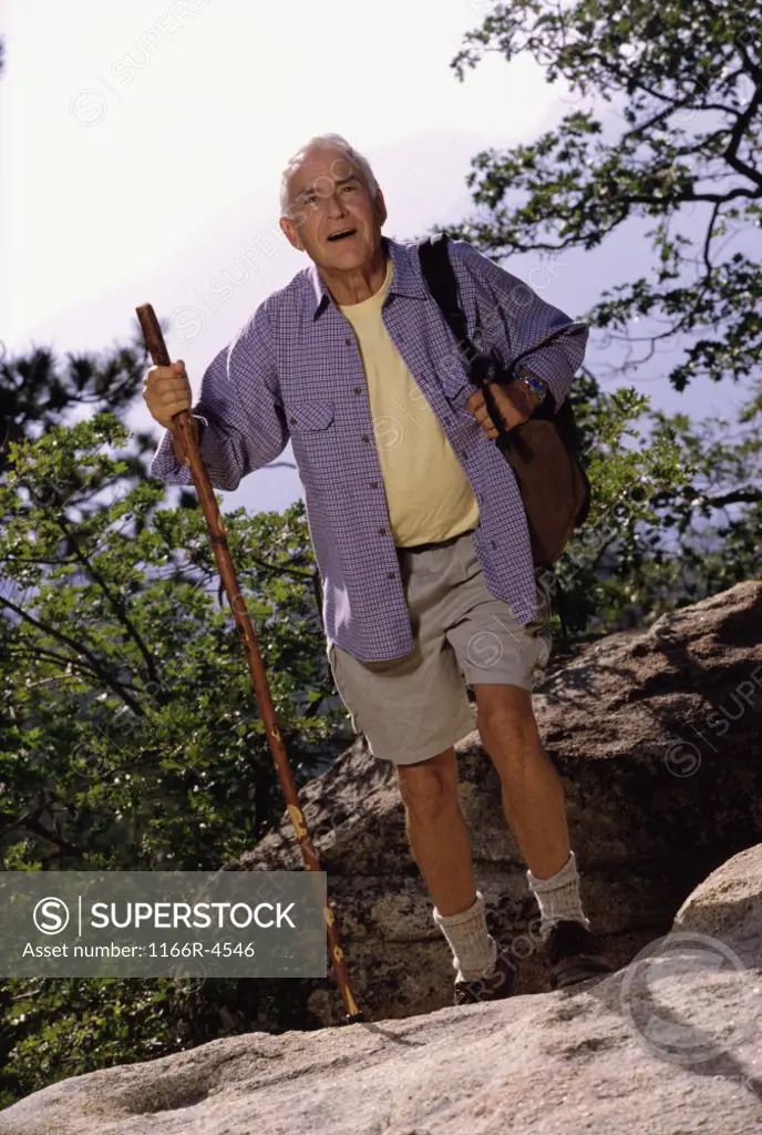 Portrait of a senior man holding a hiking pole