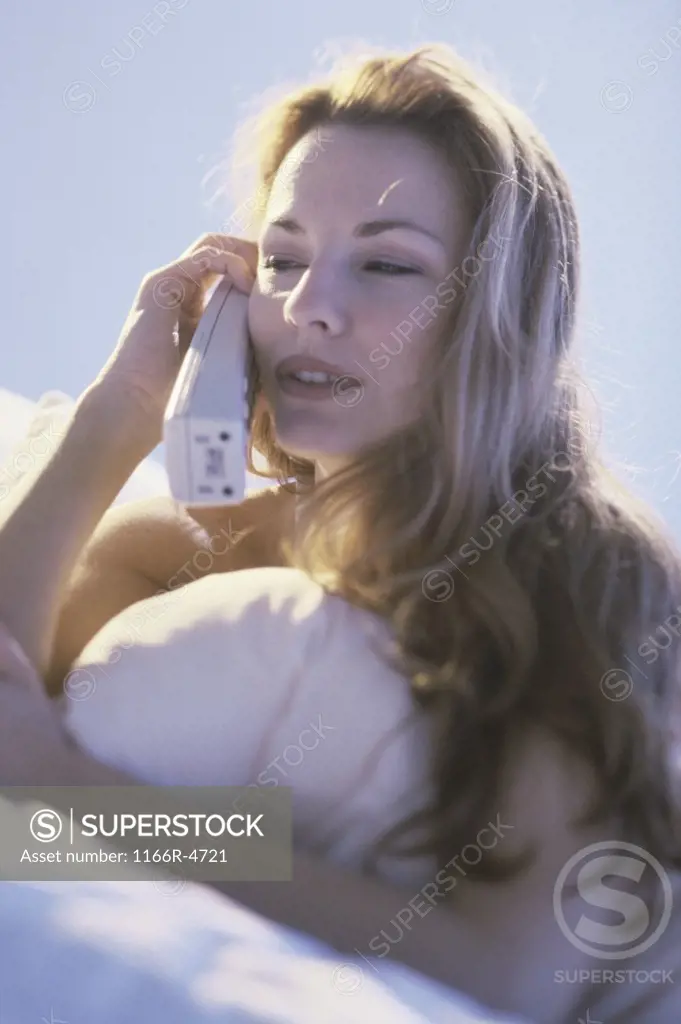 Young woman talking on a telephone