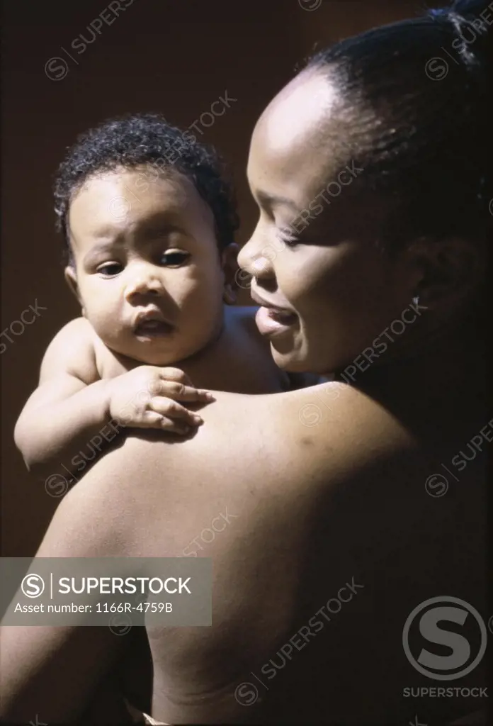 Portrait of a baby boy in his mother's arms