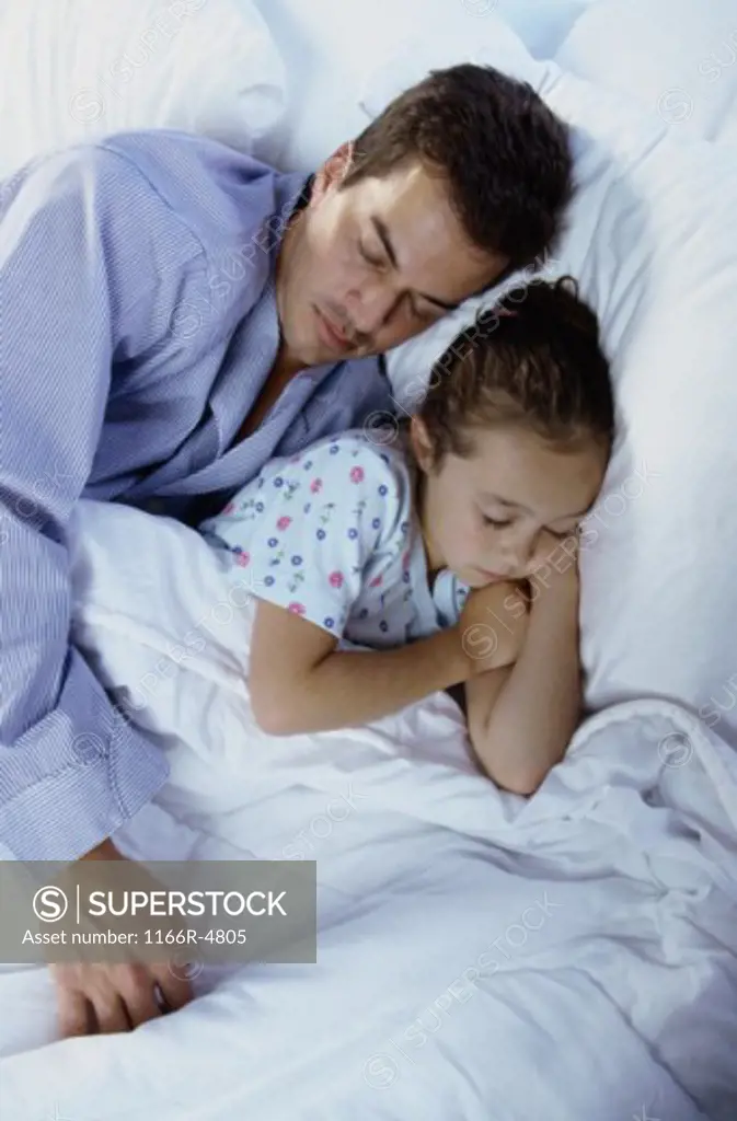 Girl sleeping with her father