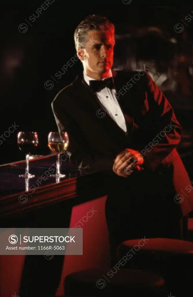 Portrait of a man leaning against a bar