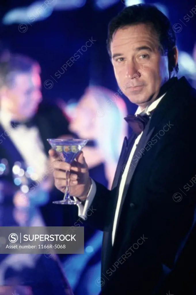 Portrait of a man holding a martini glass