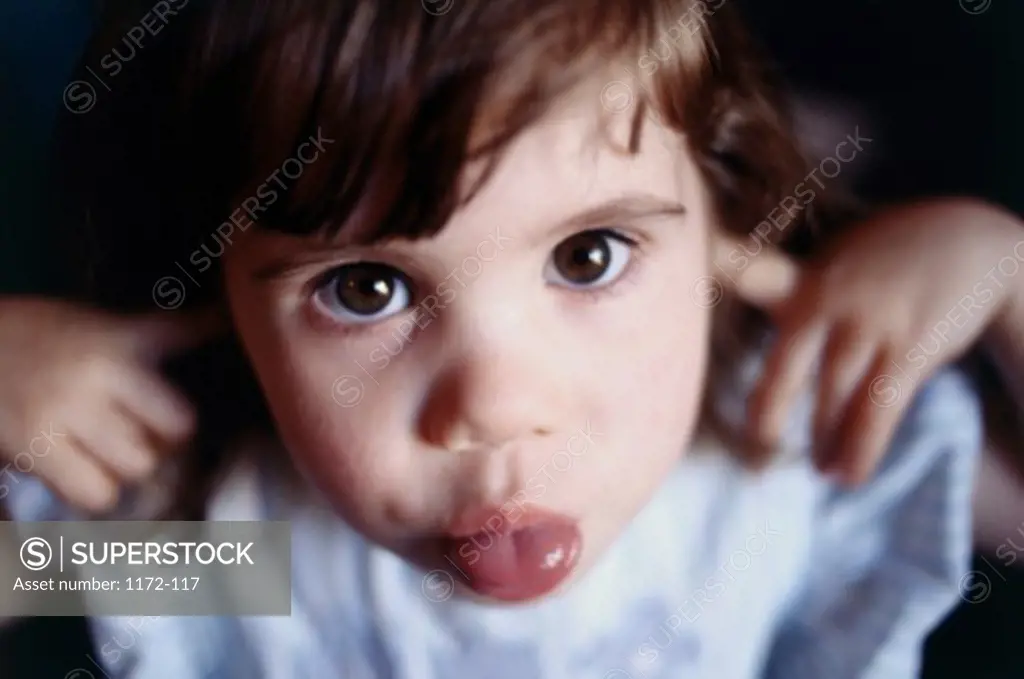 Portrait of girl sticking out her tongue