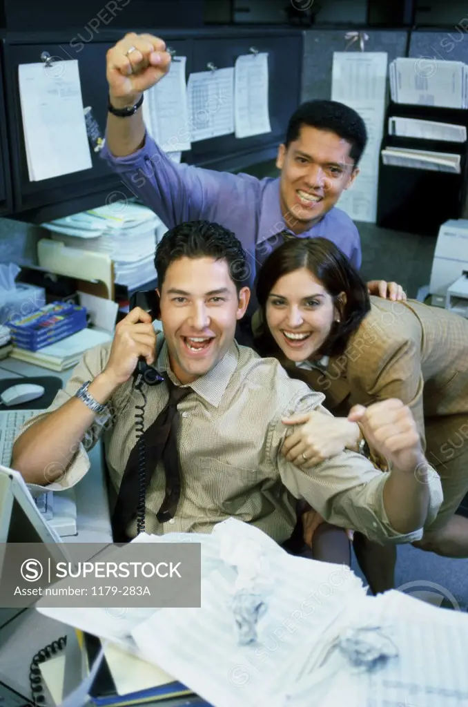 Two businessmen and a businesswoman in an office