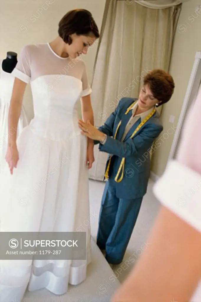 Young woman trying on a wedding gown at a bridal shop