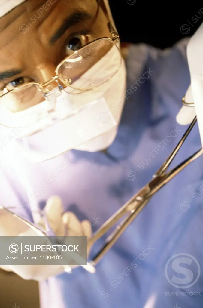 Portrait of a surgeon holding scissors