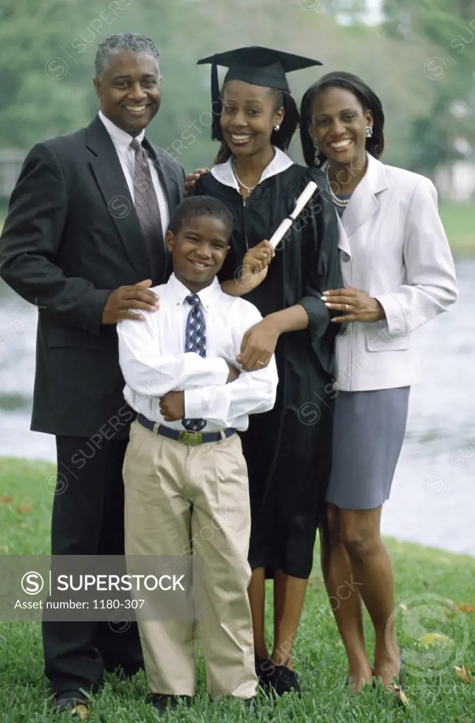 Portrait of a young female graduate with her family