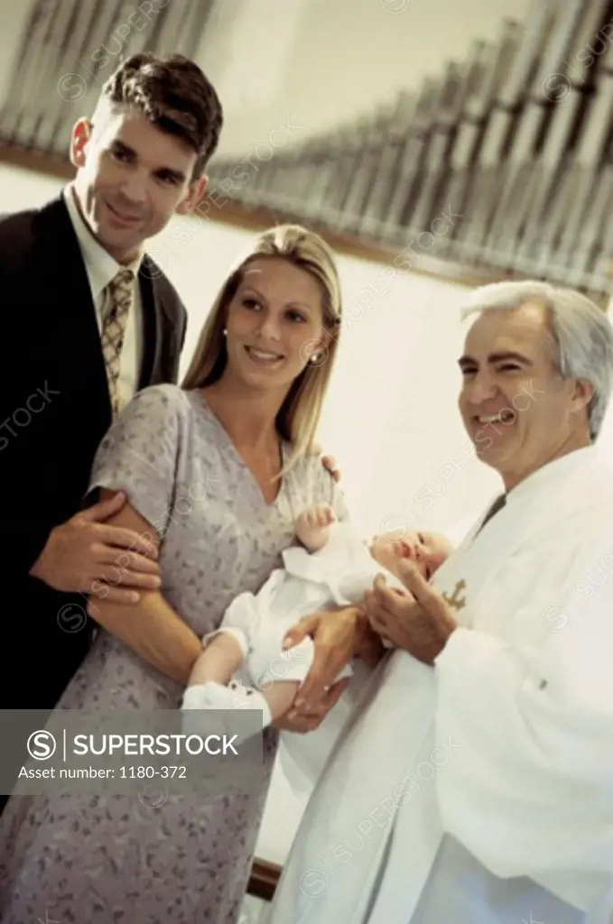 Parents with their baby girl during a baptism ceremony