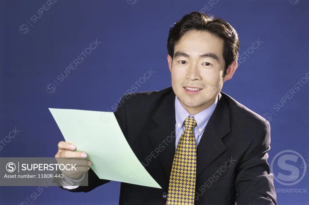 Portrait of a businessman holding a sheet of paper