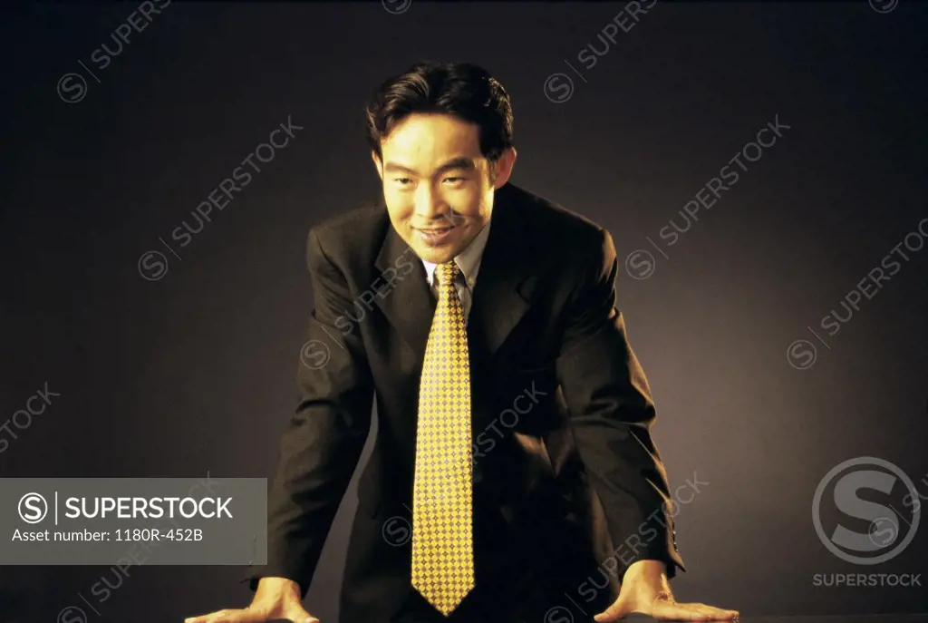 Portrait of a businessman standing behind a desk