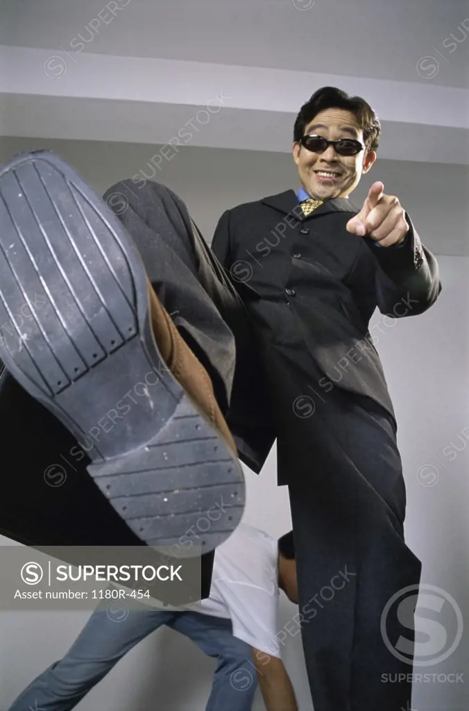 Portrait of a businessman pointing down