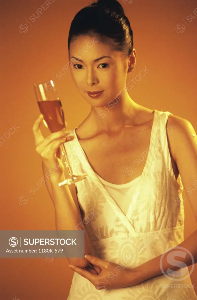 Portrait of a young woman holding a glass of champagne