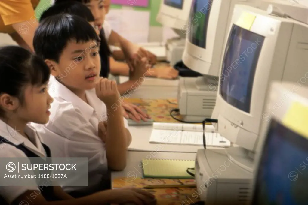 Children sitting in front of computers