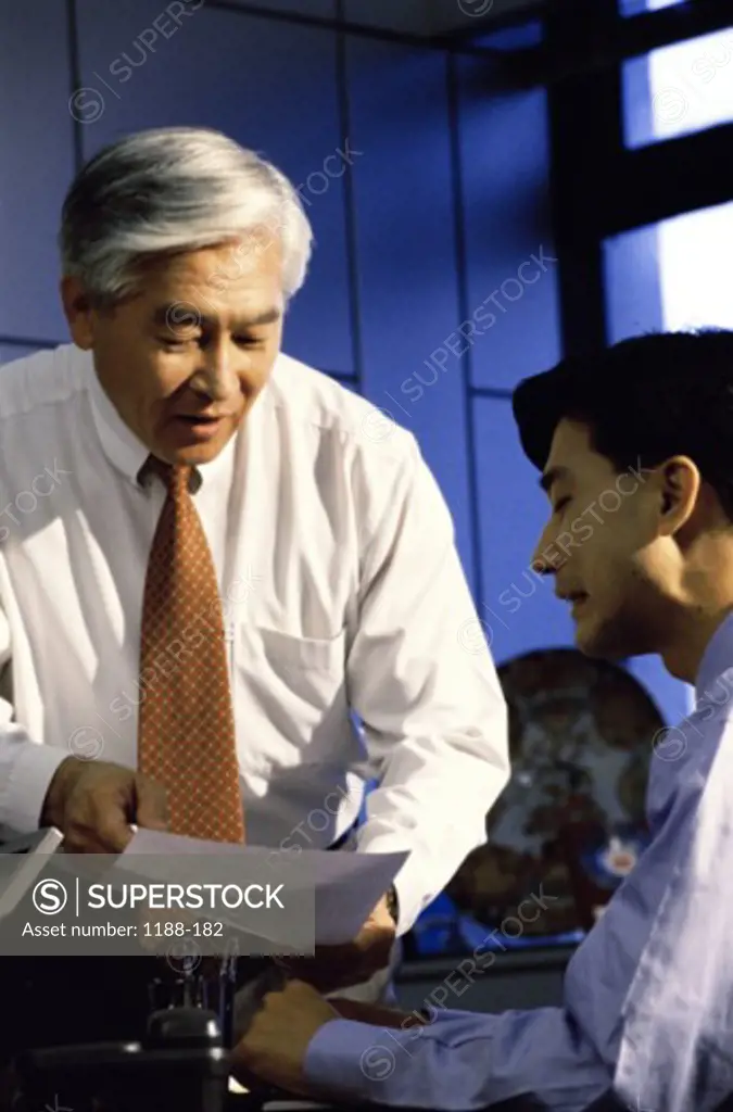 Two businessmen talking in an office