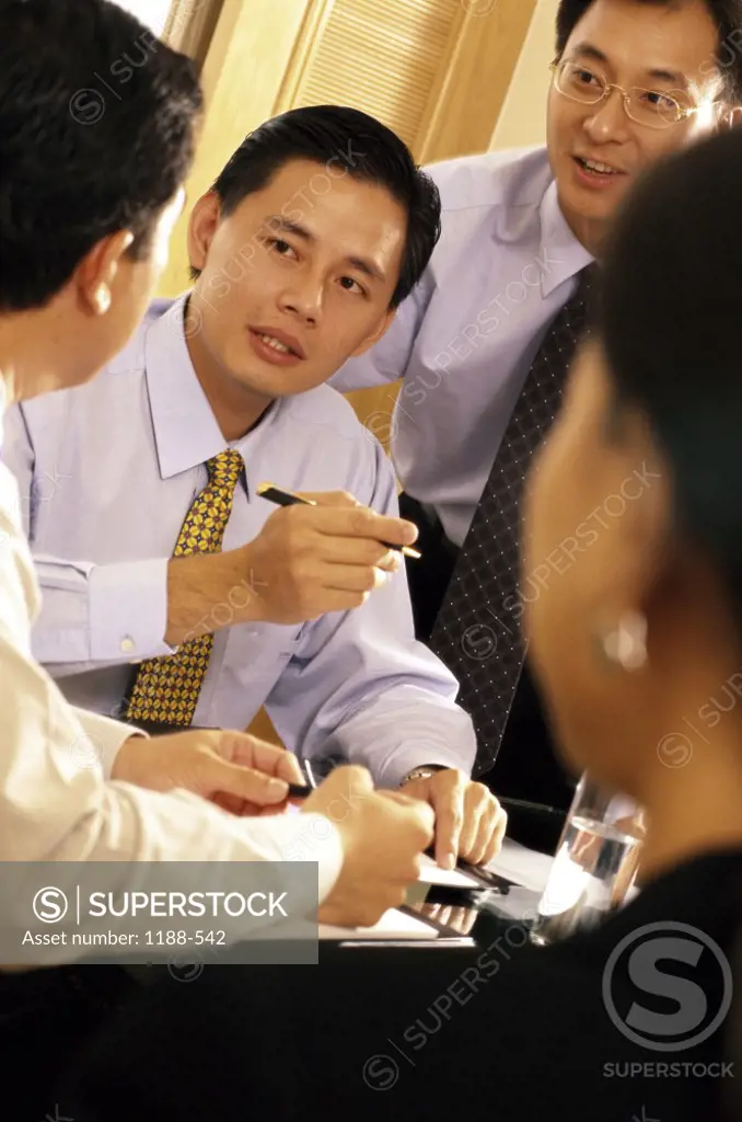 Businesswoman with three businessmen talking in an office