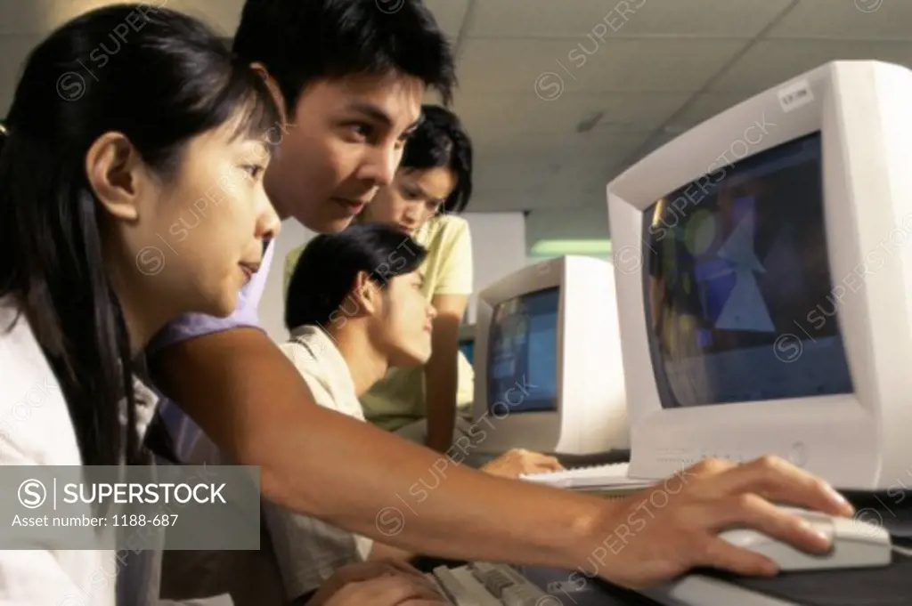 Group of teenagers in front of computers