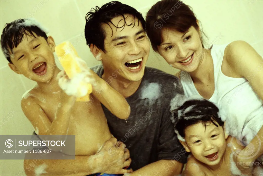 Parents and their children with soap suds