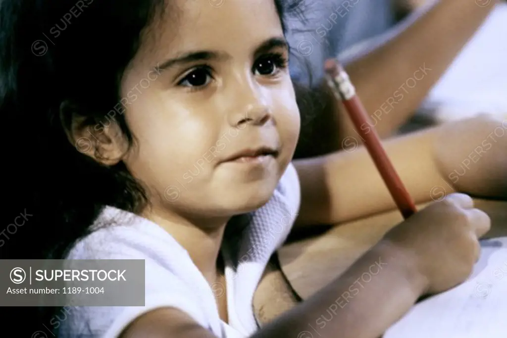 Close-up of a girl holding a pencil