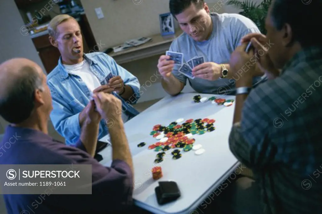 Group of mid adult men playing poker