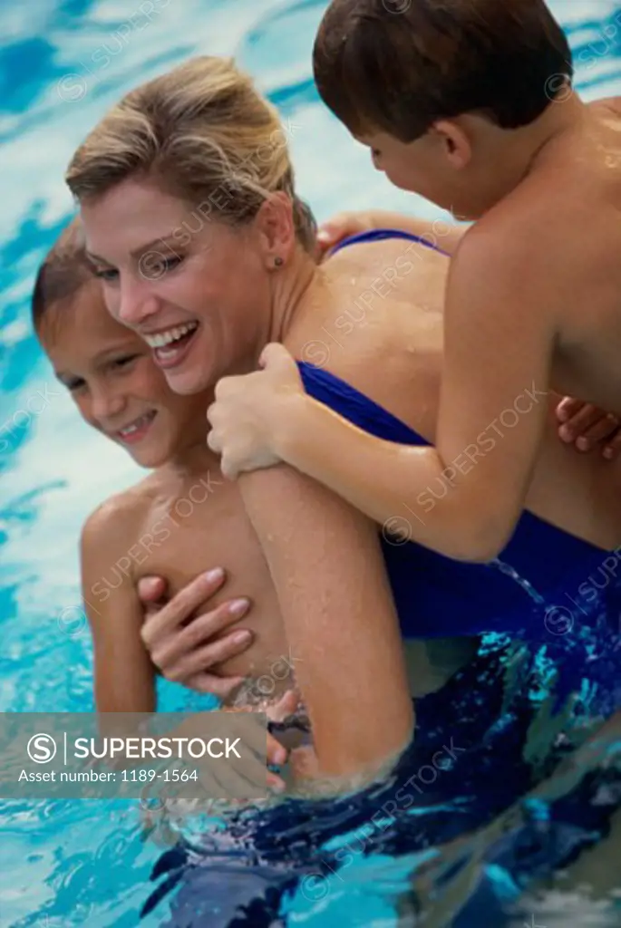 High angle view of a mother and her two sons in a swimming pool