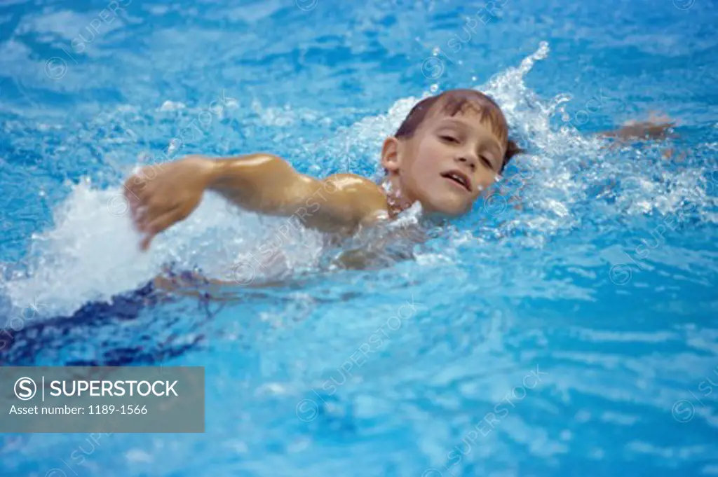 Boy swimming in a swimming pool