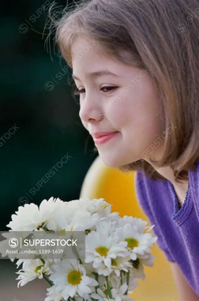Close-up of a girl holding a bunch of flowers