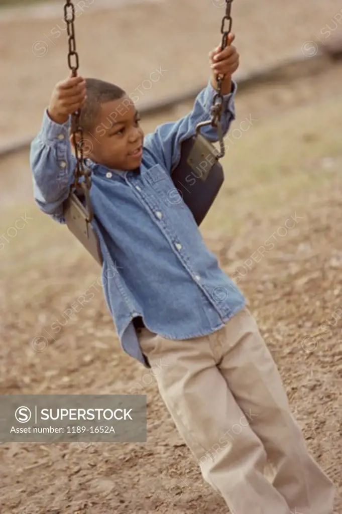 High angle view of a boy swinging on a swing