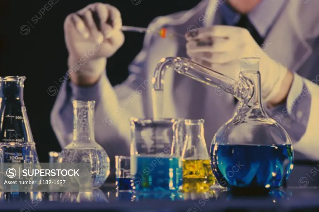 Mid section view of a scientist holding a test tube in a laboratory