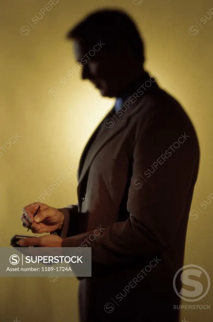 Side profile of a businessman using a hand held device
