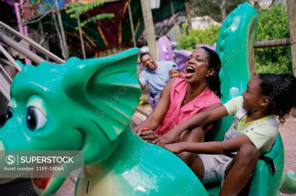 Mother and daughter riding an amusement park ride