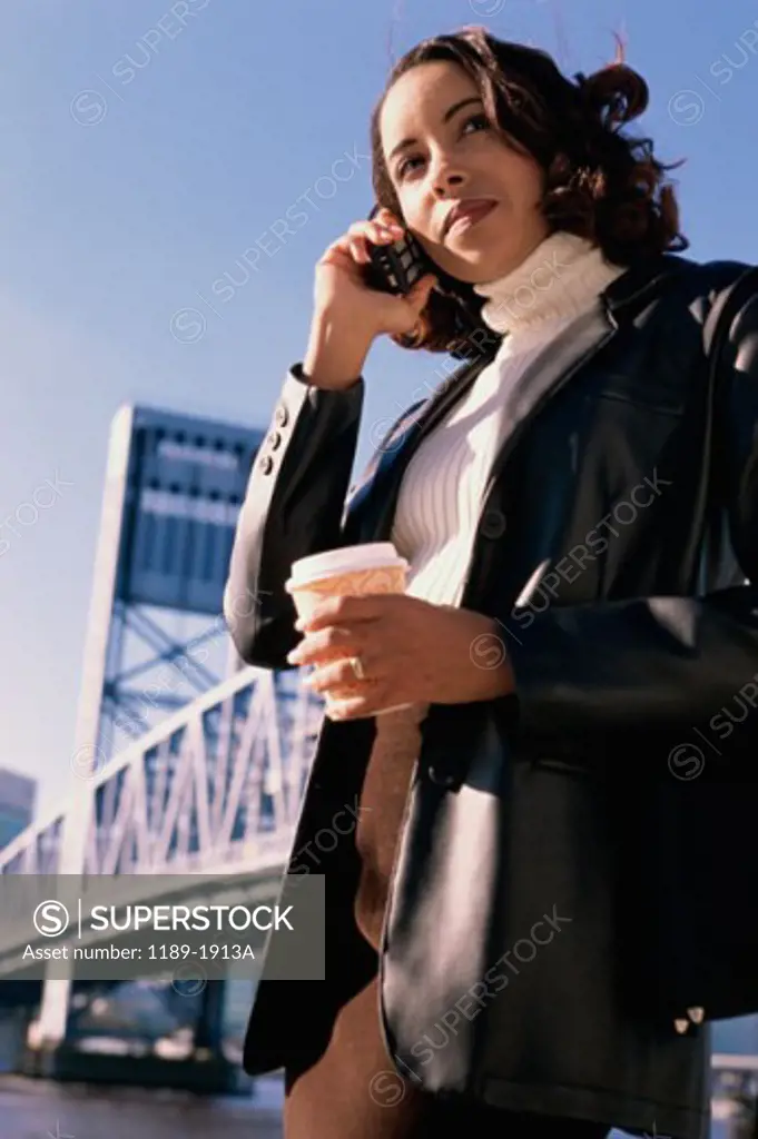 Low angle view of a young woman talking on a mobile phone