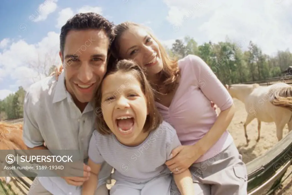 Mid adult couple with their daughter smiling