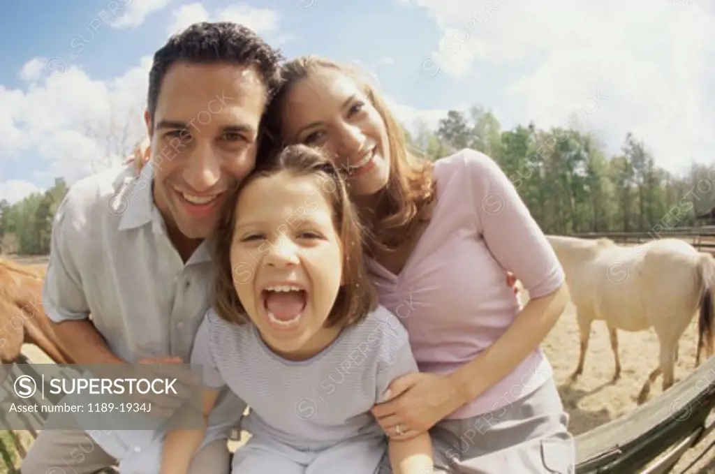Mid adult couple with their daughter smiling